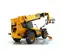 Rear angled view of yellow JCB telehandler with forklift attachment, stabilizers, boom retracted and an enclosed cabin.