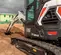 Black and white BOBCAT Mini Excavator with Reduced Tail Swing