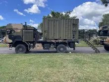 Royal Wolf's modified ICT Mobility containers for Australian Defence Force (ADF) parked in front of one another on the streets right beside a grass area